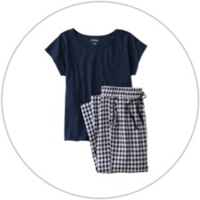 A short sleeve navy pajama shirt with navy striped pants inside a light gray circle.