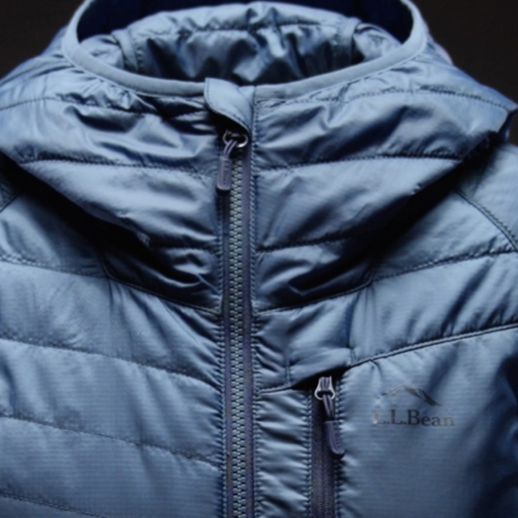 Close-up of blue L.L.Bean puffer jacket with visible L.L.Bean logo.