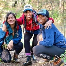 Three young women hiking on a trail