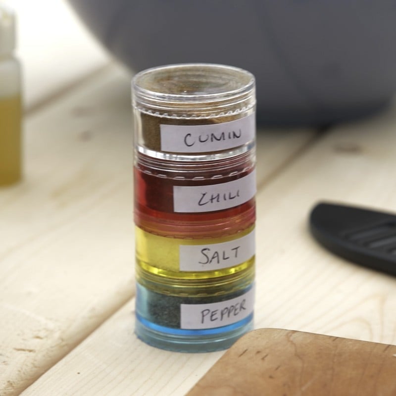 A stackable pill organizer, each compartment containing a different spice.