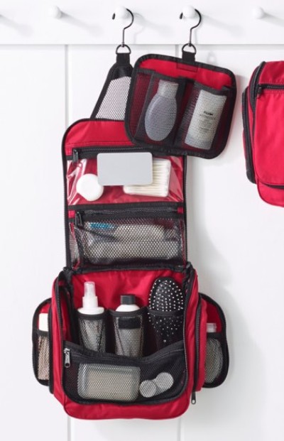 Toiletry bag hangs on hooks against a white wall, showcasing organized storage solutions.