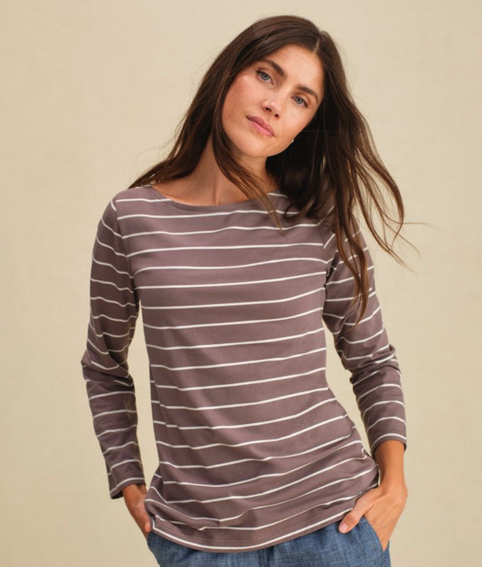 Striped long-sleeve women’s tee worn by a model. 