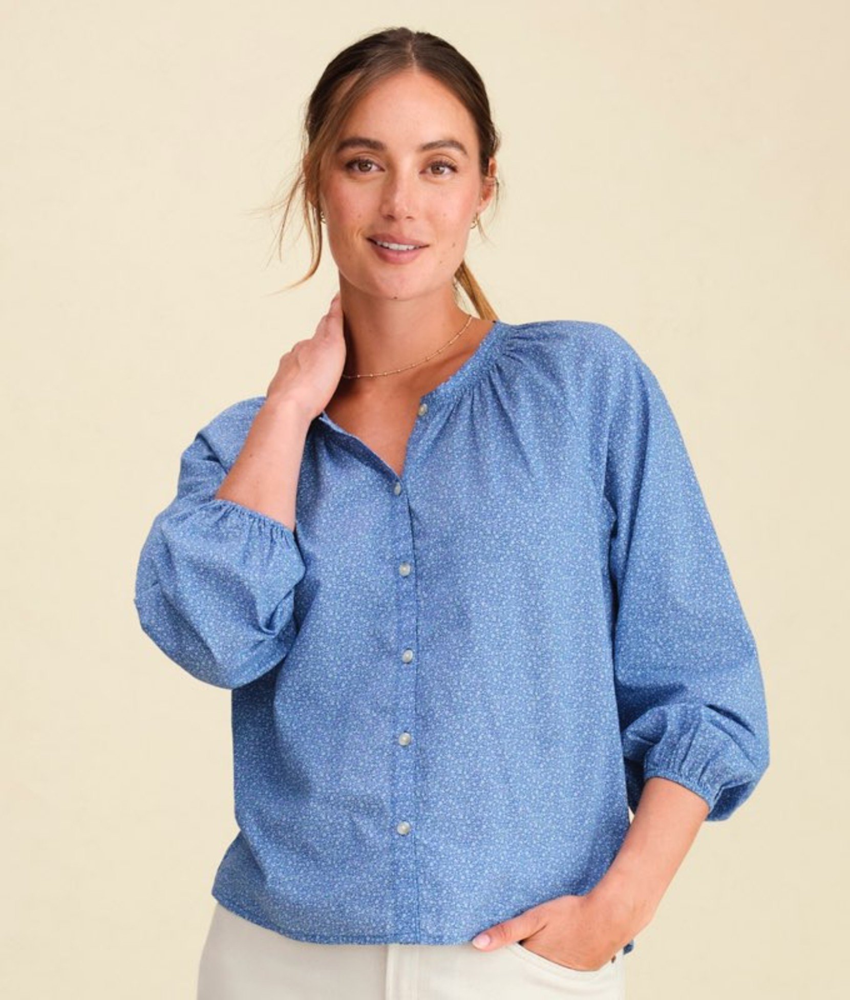 Light blue women’s button-up shirt worn by a model. 