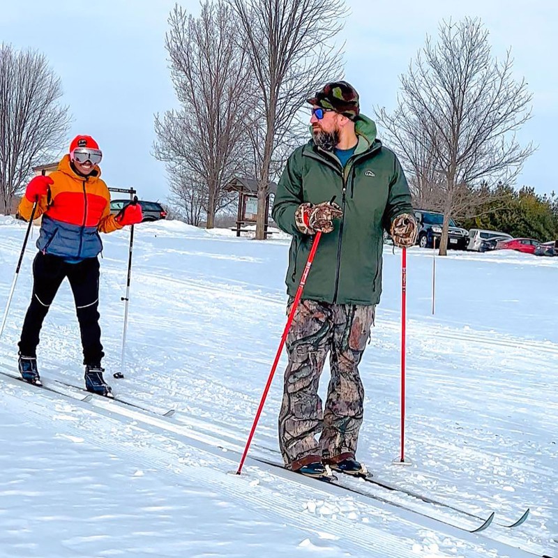 A couple learning to cross country ski.