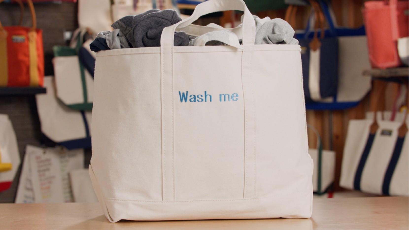 A large all white Boat & Tote with light blue monogram - Wash me