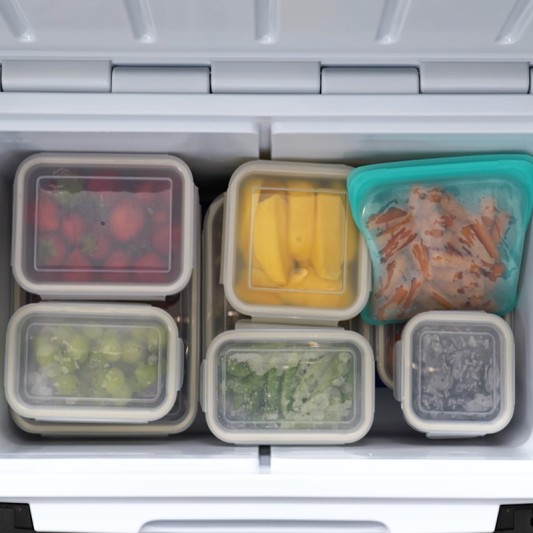 A L L Bean cooler filled with neatly organized food containers, showcasing meal prep. 