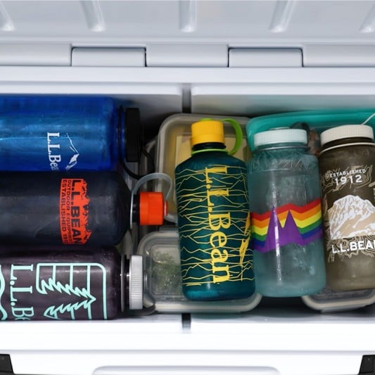 A L L Bean cooler packed with food storage containers covered with water bottles.