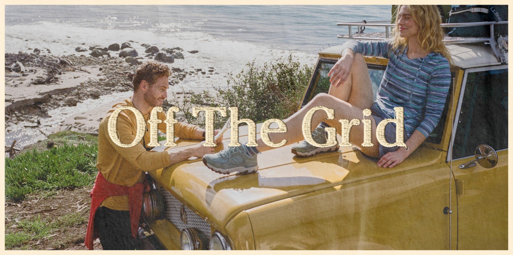 Two people beside a yellow SUV on a rocky beach, one sitting on the hood, ocean behind, text “Off The Grid”.