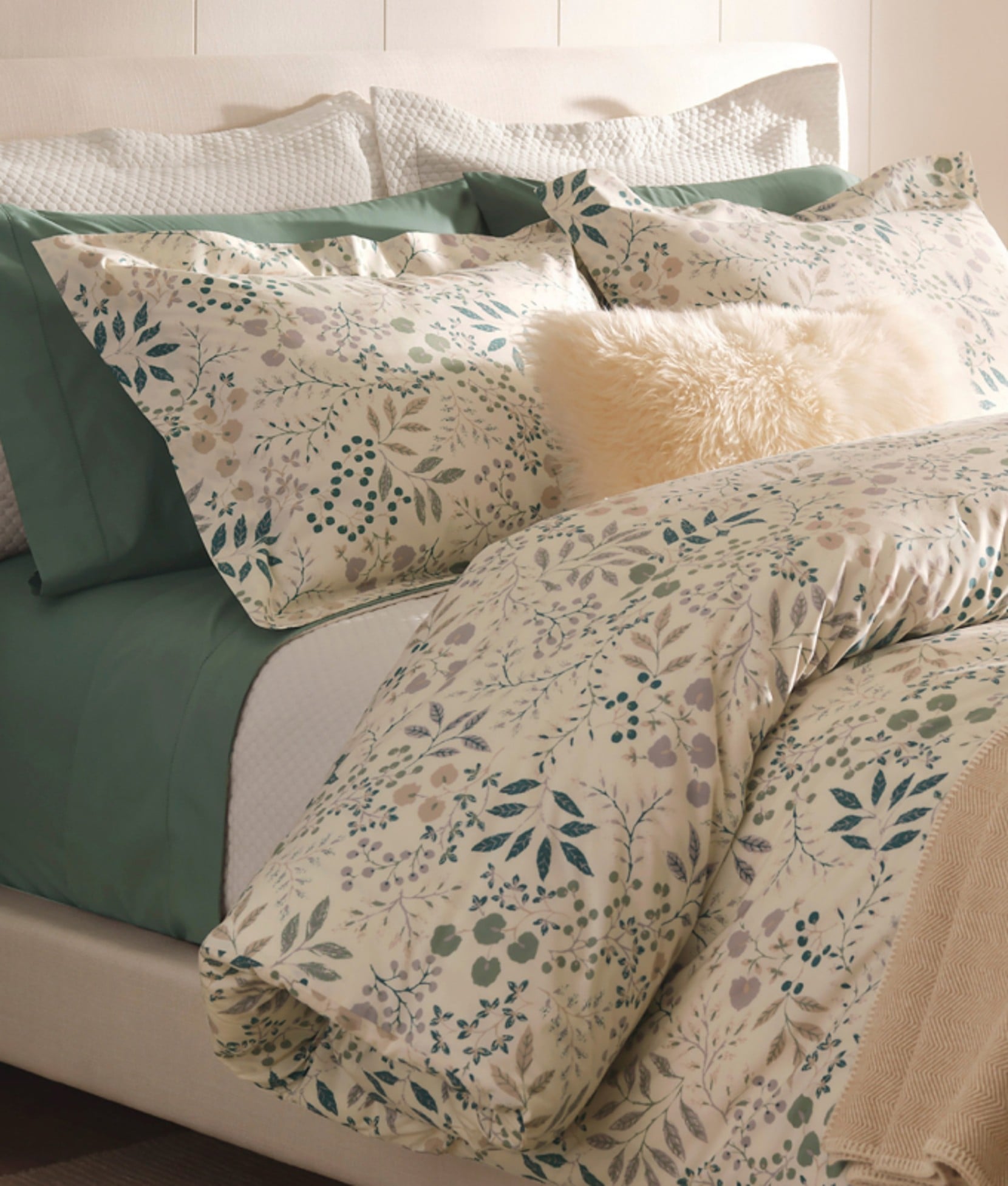 Floral-pattern bedding arranged on a neatly made bed.