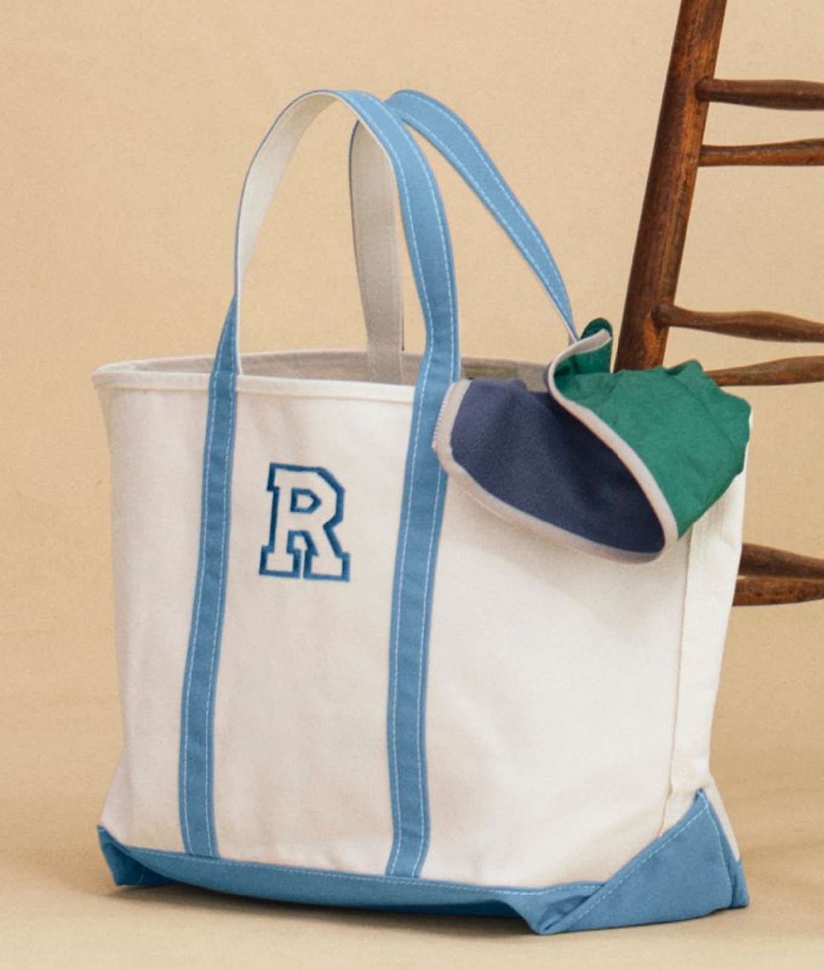 Canvas tote bag with blue trim and handles. 