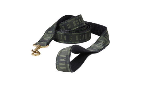A plaid dog leash with the text "L. L. Bean & Noah Kahan" printed on it.