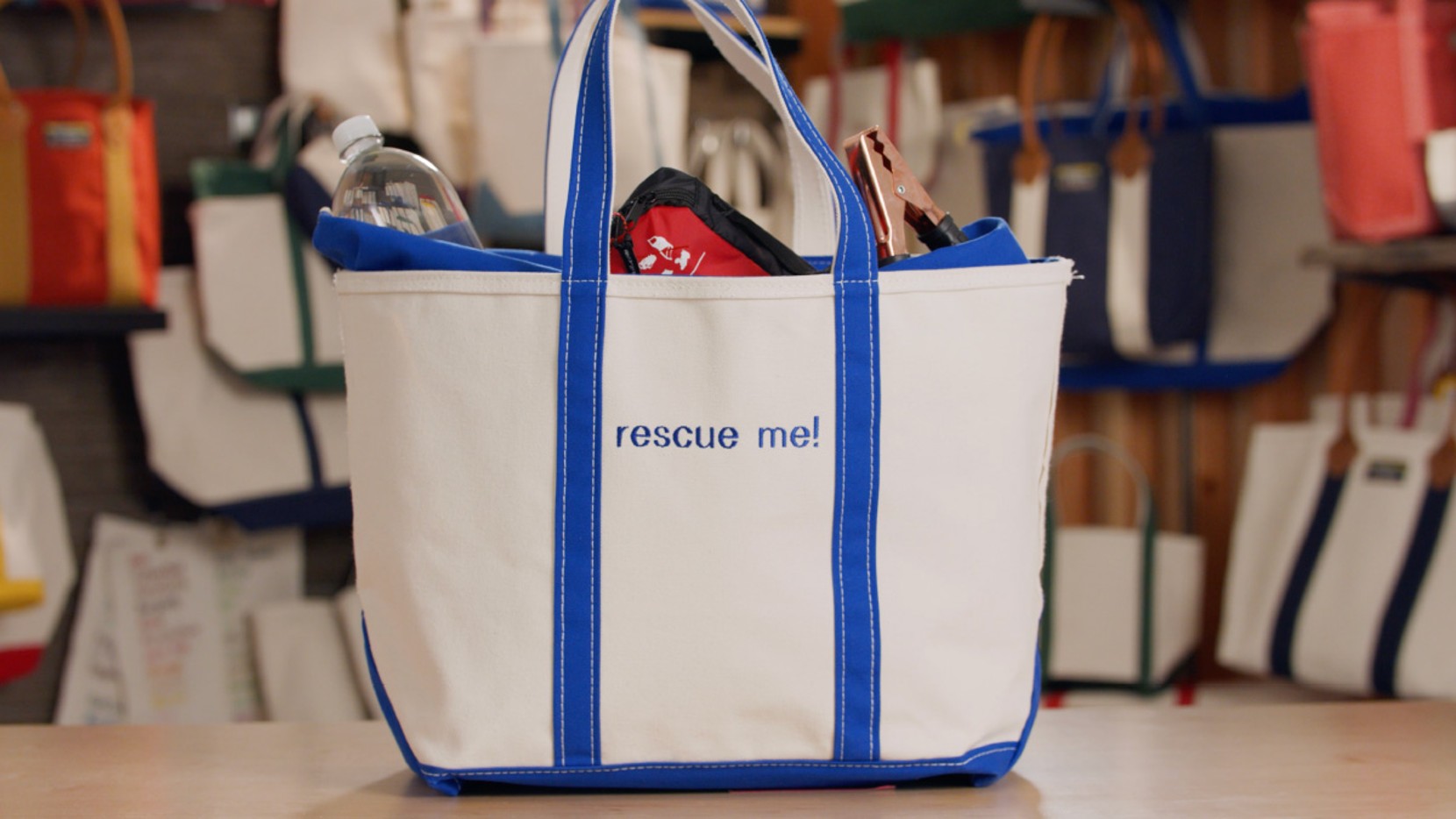 A large Boat & Tote with royal blue handles and monogram - rescue me!, filled with emergency items for the car.