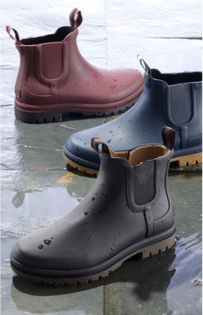 Black and burgundy waterproof Chelsea boots displayed on a wet surface.