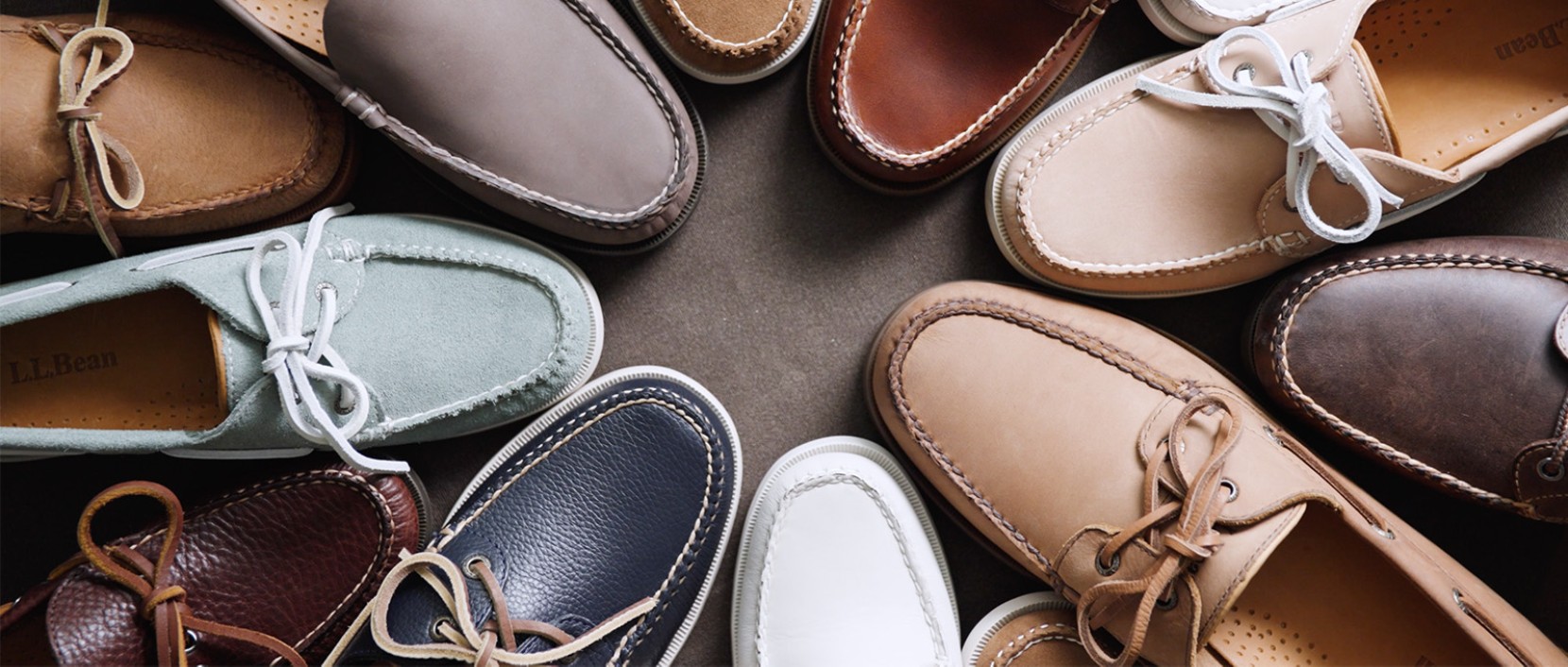 Overhead view of assorted L L Bean boat shoes in various colors arranged in a circular pattern.