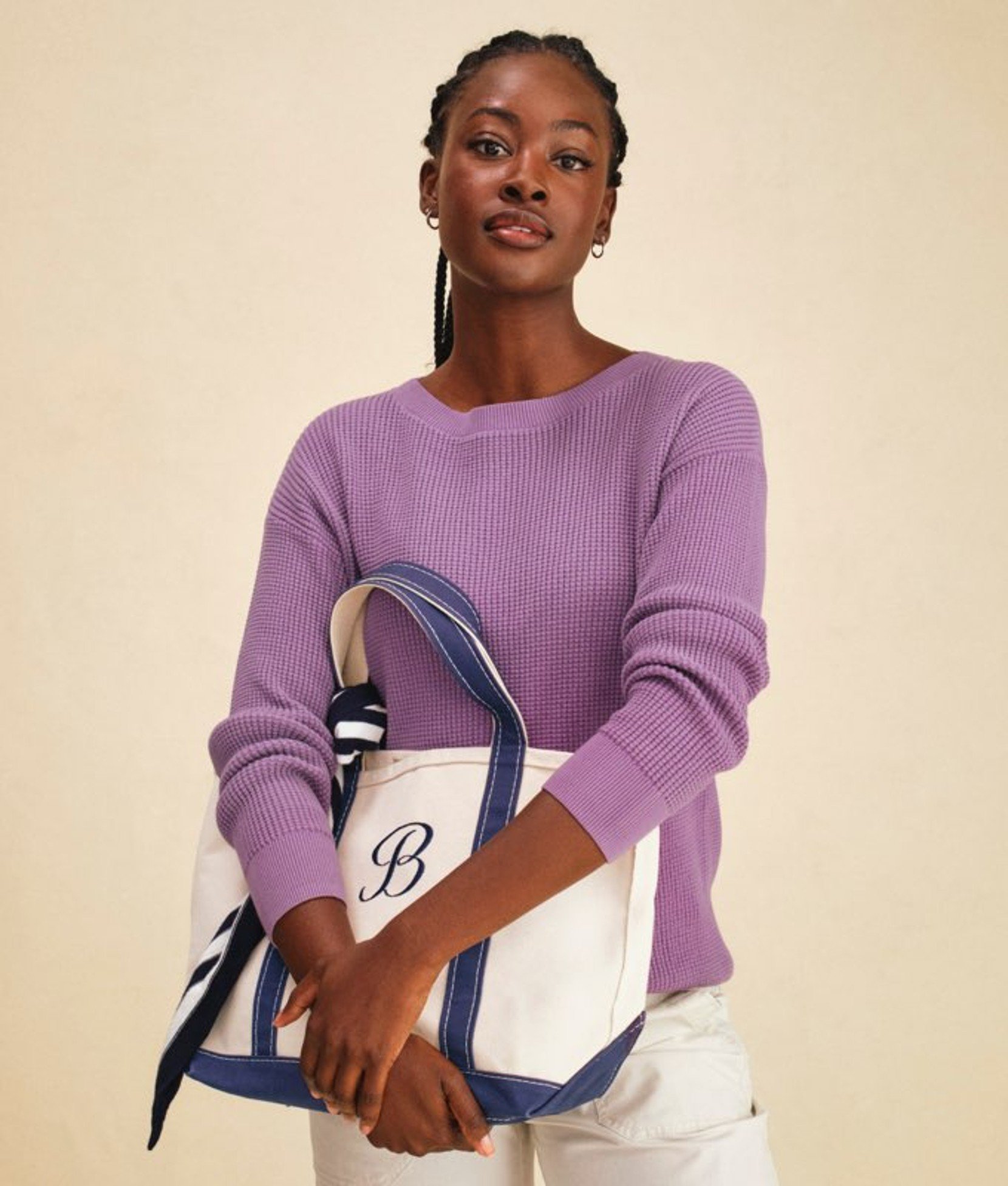 Lavender women’s sweater shown on a model holding a tote bag.