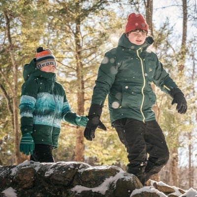 Woman wearing an L.L.Bean flannel shirt building a house of cards in an AMC (Appalachian Mountain Club) hut.