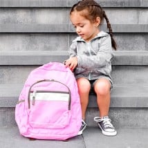 Young girl sitting on outside stairs with her bookpack