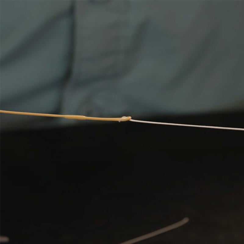 Close up of thin, yellow fishing line and the double surgeon's knot.