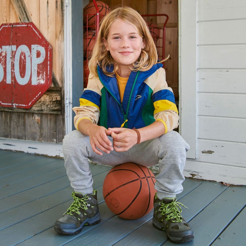 A kid sitting on a basketball.